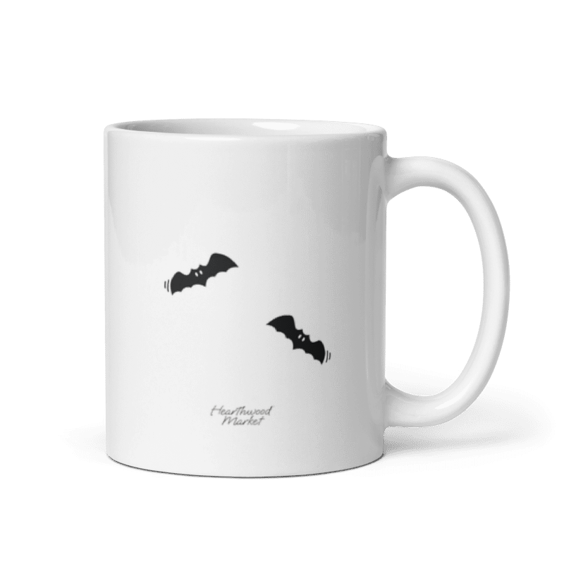 11 oz Hearthwood Market Mug back, showcasing flying bats with the store logo on the back of the mug